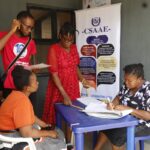 Health insurance agent supporting a Nigerian family during hospital visit