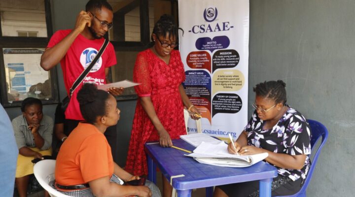Health insurance agent supporting a Nigerian family during hospital visit
