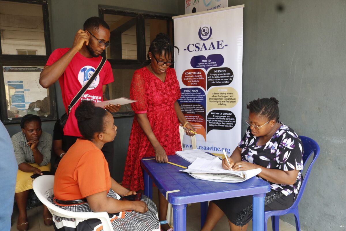 Health insurance agent supporting a Nigerian family during hospital visit